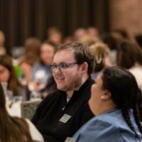 people talking at luncheon tables